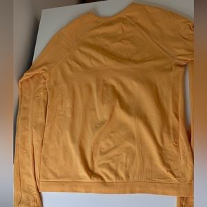 Super cute orange Athleta long sleeve swiftly. perfect condition. Size 8-10